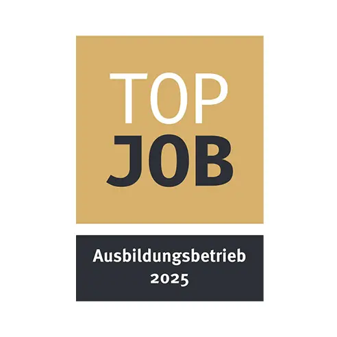A rectangular logo featuring the words "TOP JOB" in large white and black letters on a gold background. Below, the text "Ausbildungsbetrieb 2025" appears in black on a white background. The design emphasizes recognition for excellence in workplace training.